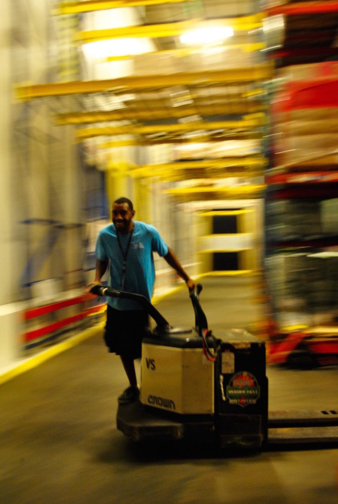 Volunteers, employees and forklifts do the heavy lifting at the Houston Food Bank.