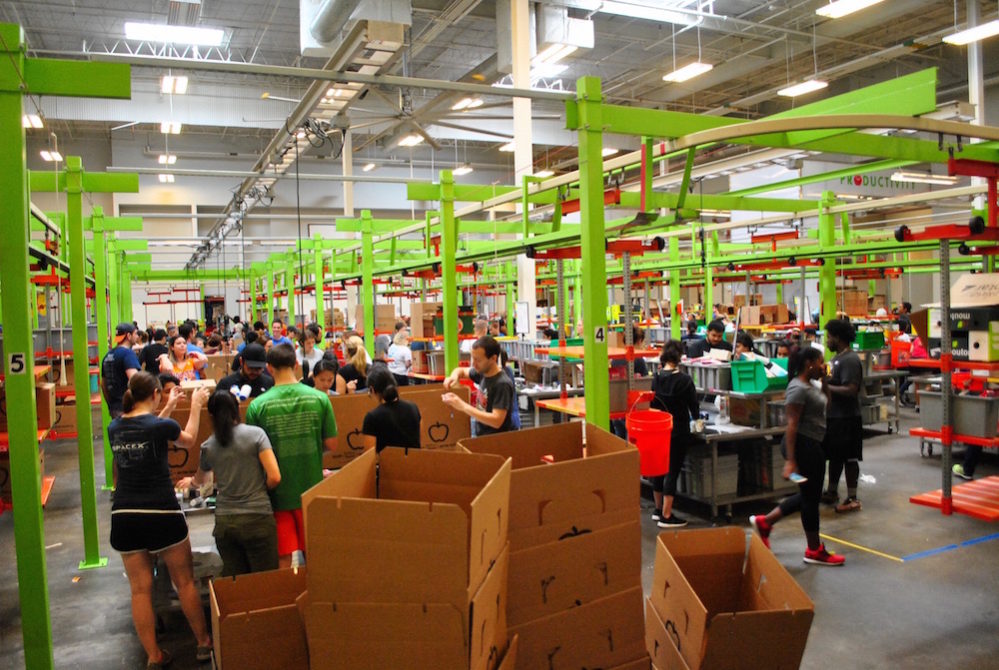 Houston Food Bank volunteers get packages boxed and organized.